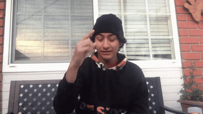 A Person Wearing A Black Beanie And A Black Sweatshirt With The Word Design On The Front GIF