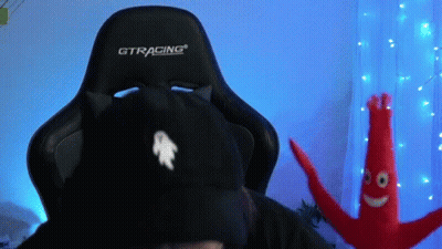 A Person Wearing A Black Cat Hat Is Sitting In A Gtracing Gaming Chair . GIF