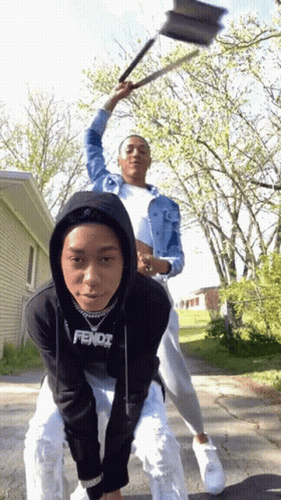 A Person Wearing A Black Fendi Sweatshirt Is Riding Another Person On Their Back GIF