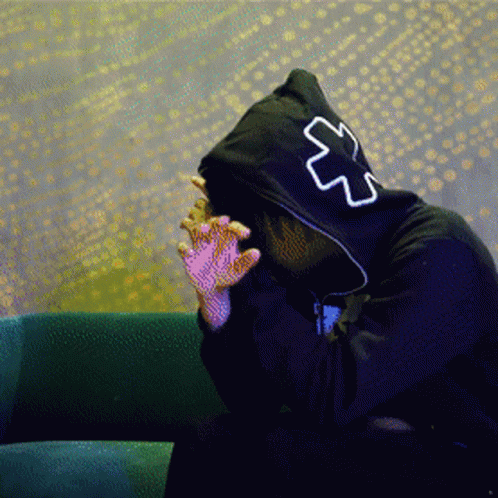 A Person Wearing A Black Hoodie With A White Cross On The Back GIF