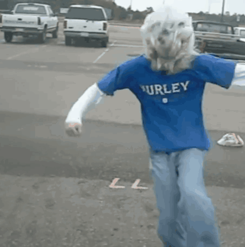 A Person Wearing A Blue Hurley Shirt Is Dancing GIF