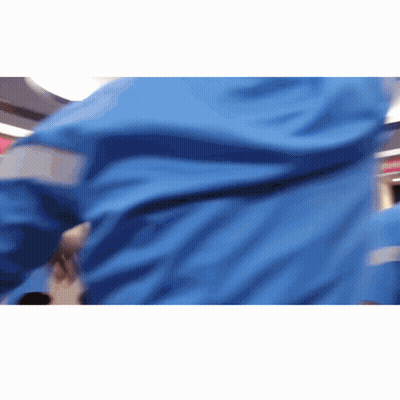 A Person Wearing A Blue Jacket With Reflective Stripes GIF