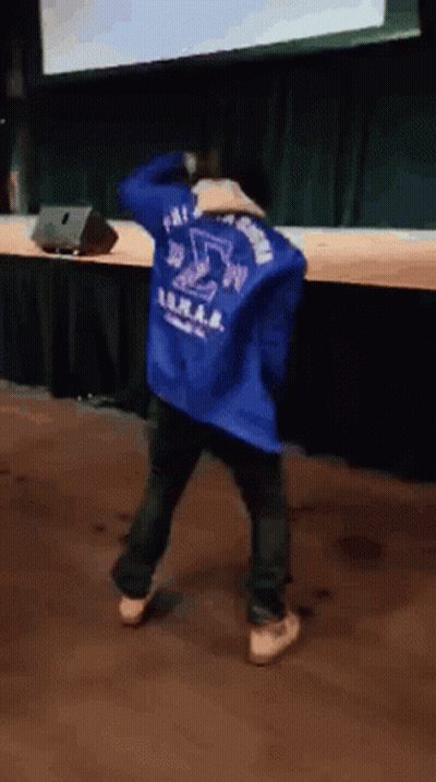 A Person Wearing A Blue Jacket With The Letter S On The Back GIF