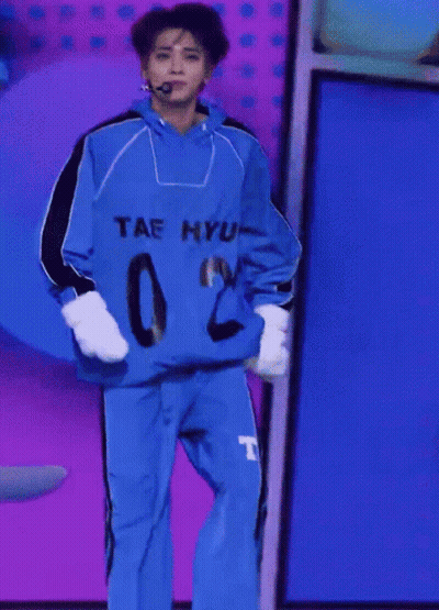 A Person Wearing A Blue Shirt That Says Tae Hyun GIF