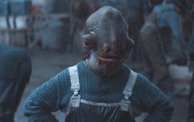 A Person Wearing A Blue Sweater And Overalls Has A Very Large Mouth GIF