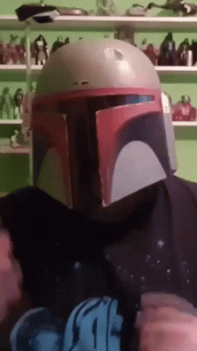 A Person Wearing A Boba Fett Helmet And A Star Wars T-Shirt GIF