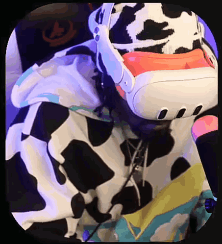 A Person Wearing A Cow Print Hoodie Is Using A Virtual Reality Headset GIF