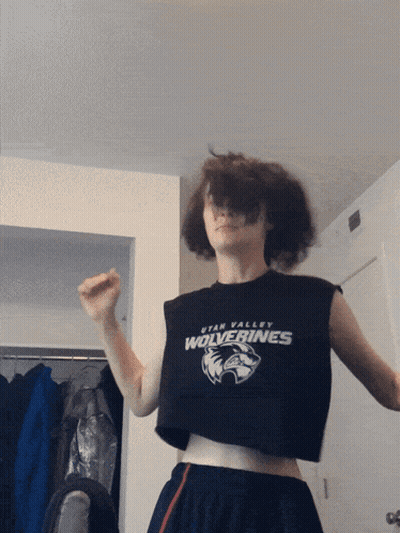 A Person Wearing A Crop Top With Utah Valley Wolverines On It GIF