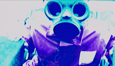 A Person Wearing A Gas Mask And Goggles With A Purple Background GIF