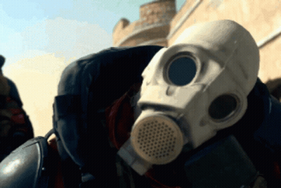 A Person Wearing A Gas Mask Is Standing In The Desert GIF