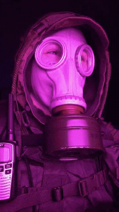 A Person Wearing A Gas Mask Next To A Walkie Talkie That Says Sony GIF