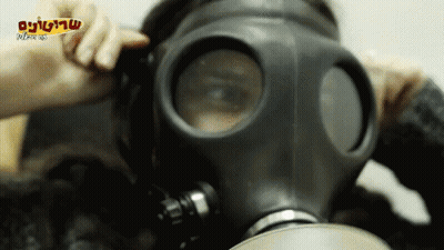 A Person Wearing A Gas Mask With A Foreign Language On The Bottom Right Corner GIF