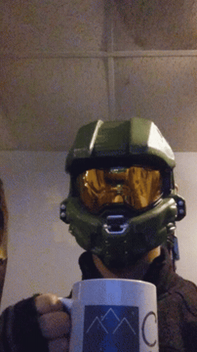 A Person Wearing A Halo Helmet Is Holding A Coffee Mug GIF