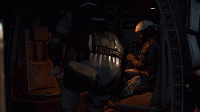A Person Wearing A Helmet And A Microphone Is Sitting Down . GIF