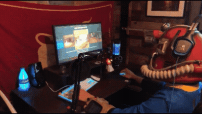 A Person Wearing A Helmet And Headphones Is Playing A Video Game GIF
