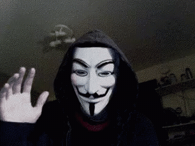 A Person Wearing A Hooded Jacket And A Anonymous Mask Is Waving GIF