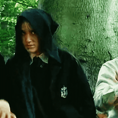 A Person Wearing A Hooded Jacket With A Crest On The Sleeve GIF