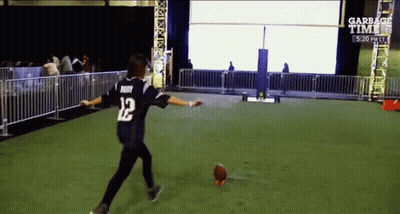 A Person Wearing A Jersey With The Number 12 On It Kicking A Football GIF