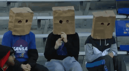 A Person Wearing A Kansas Basketball Shirt Has A Cardboard Bag Over Their Head GIF