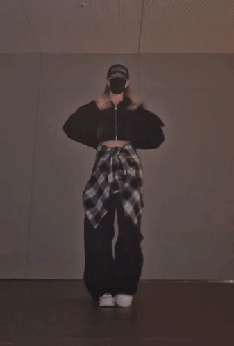 A Person Wearing A Mask And A Hat That Says Supreme Is Dancing GIF