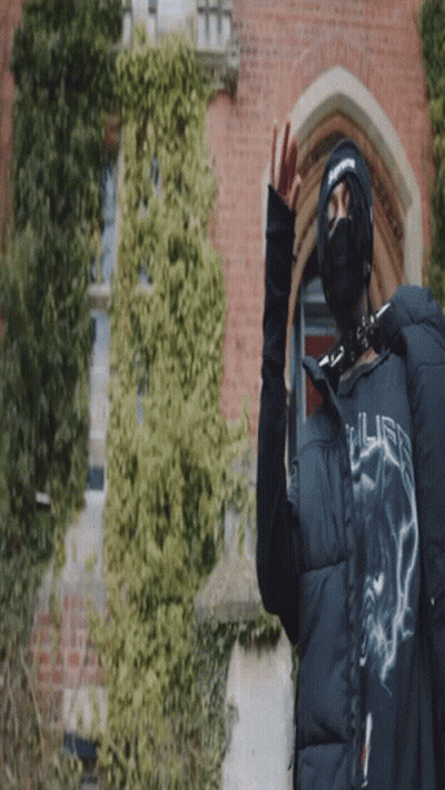 A Person Wearing A Mask And A Jacket That Says ' Supreme ' On It GIF
