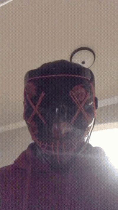 A Person Wearing A Mask With Red X 'S On The Eyes GIF