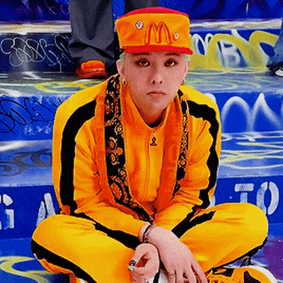 A Person Wearing A Mcdonald 'S Hat Is Sitting On A Set Of Stairs GIF