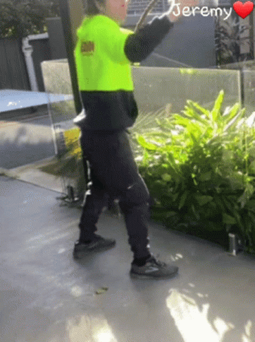 A Person Wearing A Neon Yellow Safety Vest With The Name Jeremy On It GIF