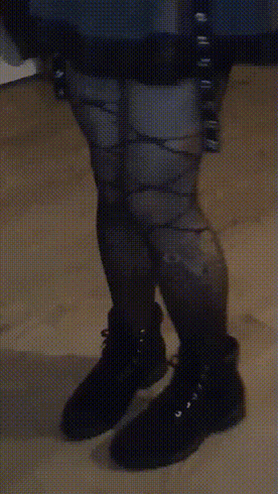 A Person Wearing A Pair Of Black Boots With A Pattern On Them GIF