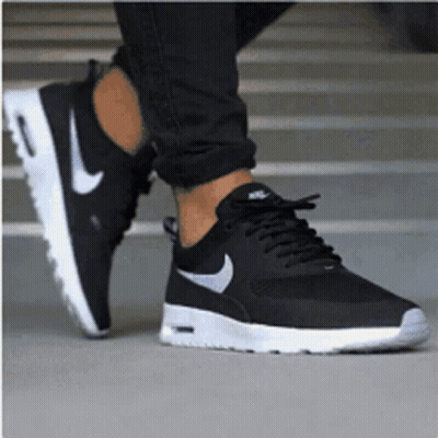 A Person Wearing A Pair Of Black Nike Air Max Thea Sneakers GIF