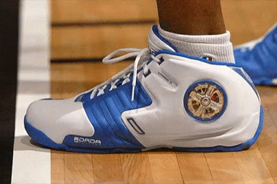 A Person Wearing A Pair Of Blue And White Shoes With The Word Dada On The Side GIF