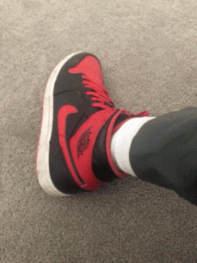 A Person Wearing A Pair Of Red And Black Air Jordans GIF