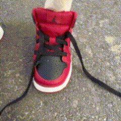 A Person Wearing A Pair Of Red And Black Sneakers GIF