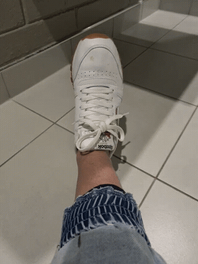 A Person Wearing A Pair Of Reebok Sneakers GIF