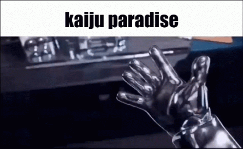 A Person Wearing A Pair Of Silver Gloves Is Waving At The Camera . GIF