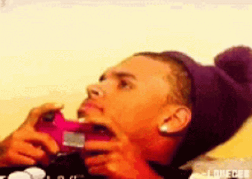 A Person Wearing A Purple Hat Is Taking A Picture With A Pink Phone GIF