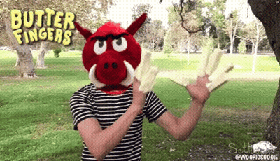 A Person Wearing A Red Boar Mask With Butter Fingers Written On The Top GIF