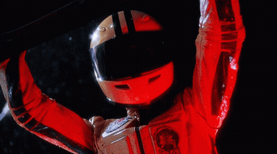 A Person Wearing A Red Helmet And A Red Jacket With A Star Wars Emblem GIF