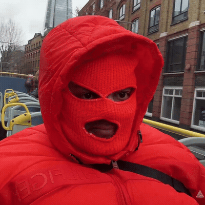 A Person Wearing A Red Ski Mask And A Red Jacket With The Word Ice On The Front GIF