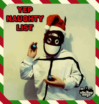 A Person Wearing A Santa Hat And Mask Holding A Christmas Ornament With The Words Yep Naughty List Written Above Them GIF