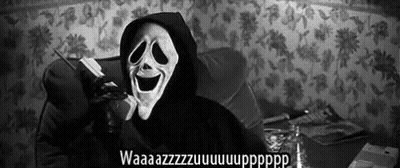 A Person Wearing A Scream Mask Is Talking On A Cell Phone . GIF
