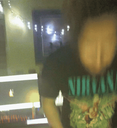 A Person Wearing A Shirt That Says Nirvana On It GIF