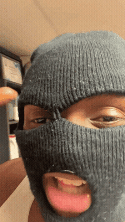 A Person Wearing A Ski Mask Is Sticking Out Their Tongue GIF