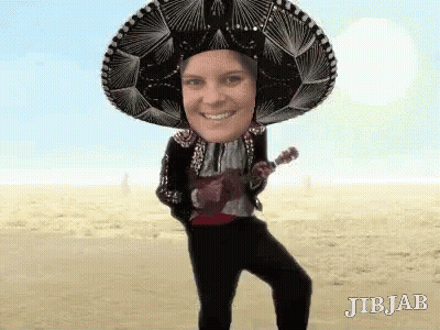 A Person Wearing A Sombrero And Holding An Ukulele . GIF