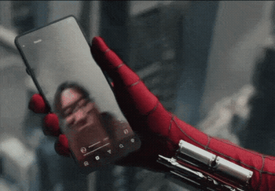 A Person Wearing A Spiderman Glove Is Holding A Phone GIF