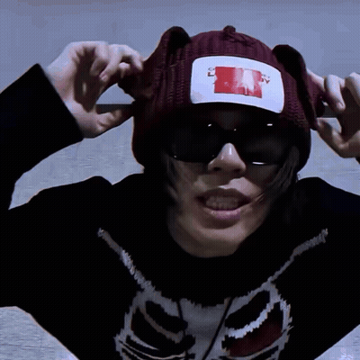 A Person Wearing A Sweater With A Skeleton On It And A Beanie That Says " I Love You " On It GIF