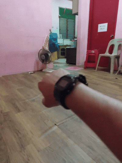 A Person Wearing A Watch Stands In A Room With A Sign On The Door That Says ' No Smoking ' GIF