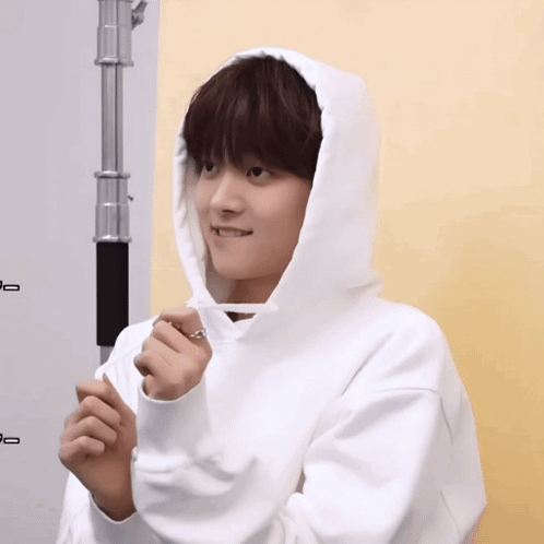 A Person Wearing A White Hoodie With A Ring On It GIF
