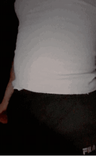 A Person Wearing A White Shirt And Black Shorts With Fila On Them GIF