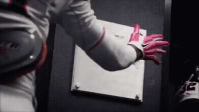 A Person Wearing A White Shirt And Pink Gloves Is Holding A White Board . GIF